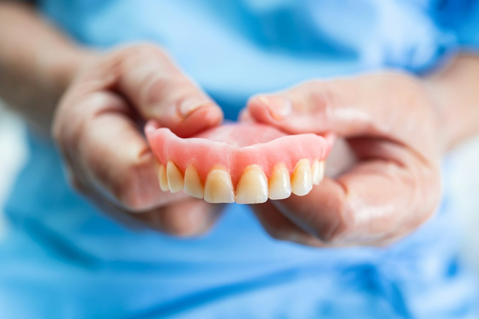 Asian senior woman patient holding to use denture